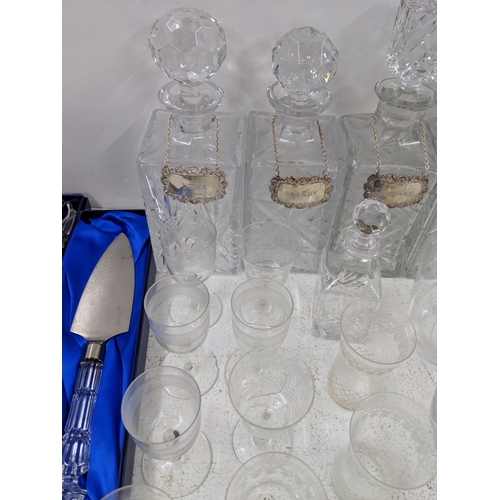 37 - A collection of glassware along with four crystal decanters all with decanter labels, one silver hal... 