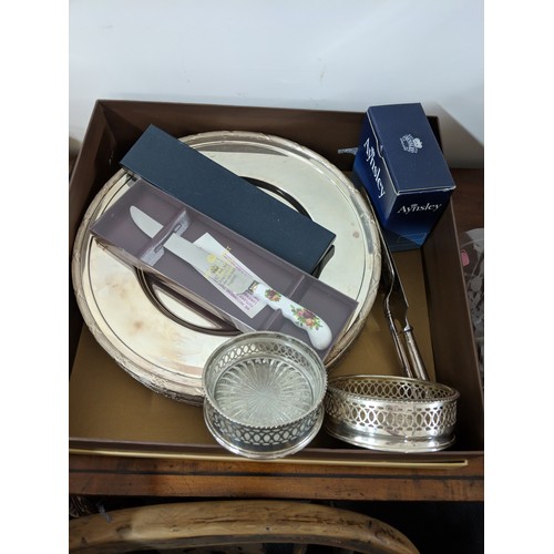 38 - A small collection of silver plates to include a set of twelve dinner plates, two cake servers, wine... 