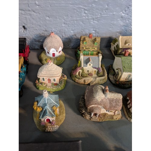 47 - A collection of model buildings mainly by New England Miniatures, to include cottages, churches, sch... 