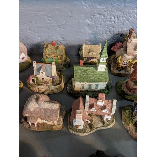 47 - A collection of model buildings mainly by New England Miniatures, to include cottages, churches, sch... 