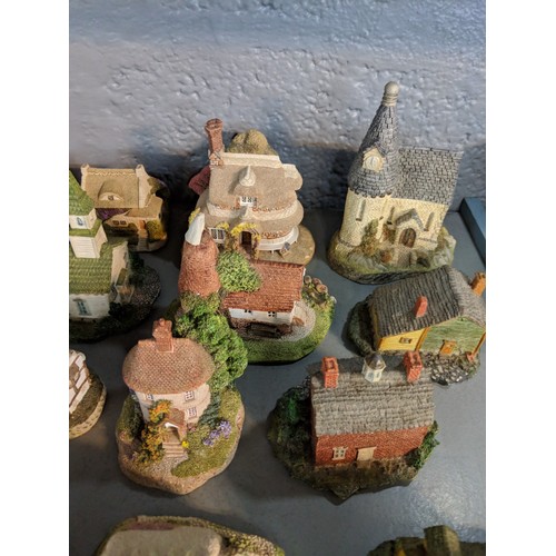 47 - A collection of model buildings mainly by New England Miniatures, to include cottages, churches, sch... 