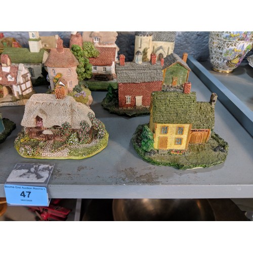 47 - A collection of model buildings mainly by New England Miniatures, to include cottages, churches, sch... 