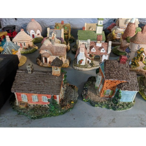 47 - A collection of model buildings mainly by New England Miniatures, to include cottages, churches, sch... 