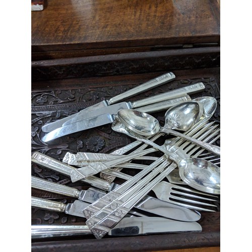 48 - A mixed lot to include silver plated cutlery, a Doulton Lambeth vase, a large carved tray, a teapot ... 