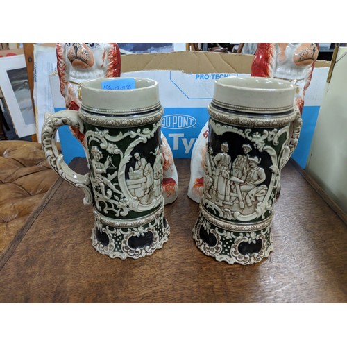 48A - Two Staffordshire pottery model dogs along with two beer steins depicting traditional scenes
Locatio... 