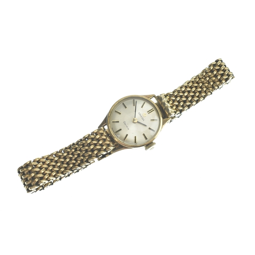 21 - An Omega 9ct gold, ladies, manual wind wristwatch, having a silvered dial with gilt baton markers, f... 