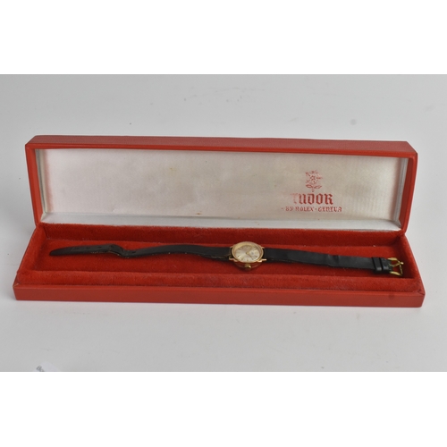 22 - A Tudor 9ct gold ladies manual wind wristwatch, the silvered dial having gilt baton markers, on a la... 