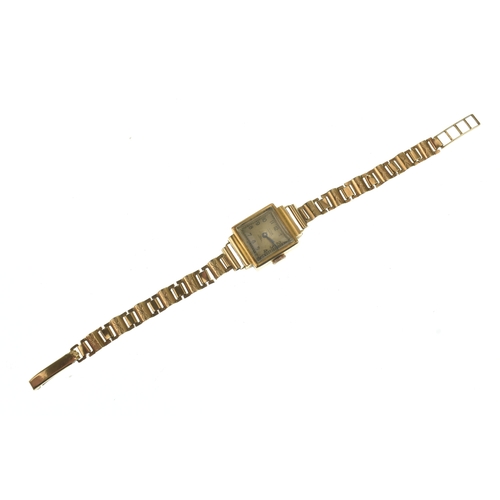 31 - A Titus 18ct gold ladies manual wind wristwatch, having a square silvered dial with Arabic numerals ... 