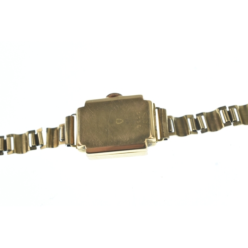 31 - A Titus 18ct gold ladies manual wind wristwatch, having a square silvered dial with Arabic numerals ... 