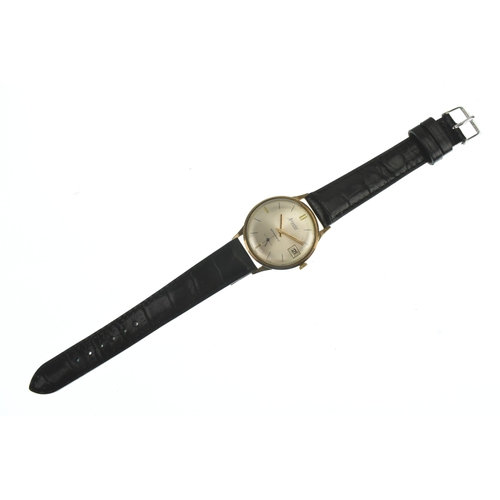 43 - An Accurist 9ct, gents, manual wind wristwatch, having a silvered dial with baton markers, date aper... 