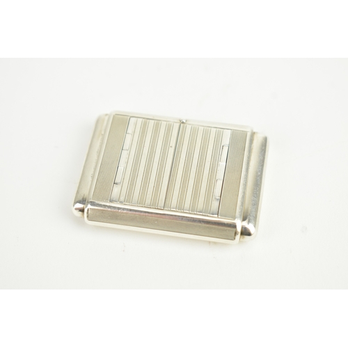 5 - An Art Deco Tavannes silver purse watch, having an engine turned case, twin buttons operating the me... 