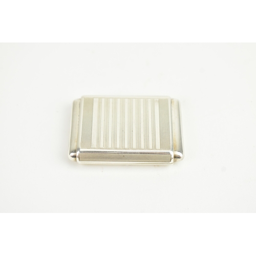 5 - An Art Deco Tavannes silver purse watch, having an engine turned case, twin buttons operating the me... 