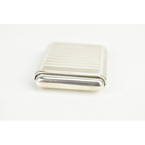 5 - An Art Deco Tavannes silver purse watch, having an engine turned case, twin buttons operating the me... 