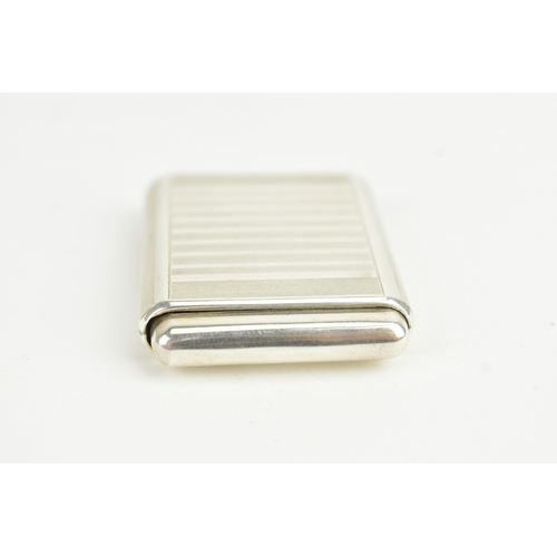 5 - An Art Deco Tavannes silver purse watch, having an engine turned case, twin buttons operating the me... 