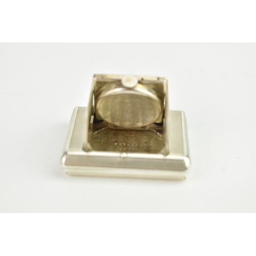 5 - An Art Deco Tavannes silver purse watch, having an engine turned case, twin buttons operating the me... 