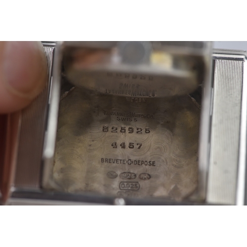 5 - An Art Deco Tavannes silver purse watch, having an engine turned case, twin buttons operating the me... 