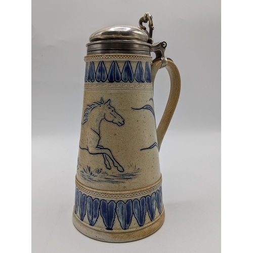 A Doulton Lambeth salt glazed stoneware tankard with a silver domed lid, thumb piece and collar, the conical shaped body decorated with a pony and stylized leaf-shaped bands in blue, in the style of Hanna Barlow, London 1871, by Richards & Brown, 25cm high
Location: R1-1
If there is no condition report shown, please request