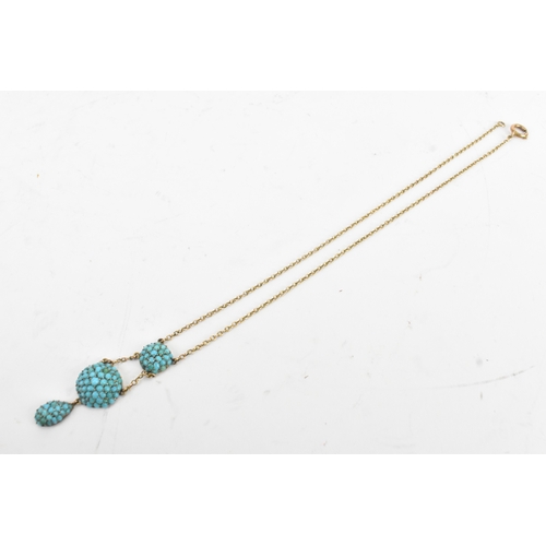 11 - A Victorian turquoise pave set 9ct gold necklace, the chain suspending three graduated domed cluster... 