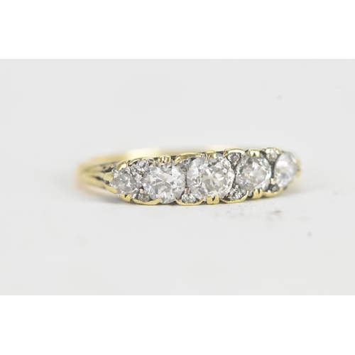 14 - A late 19th/early 20th century diamond yellow gold engagement ring, unmarked, set with five graduate... 
