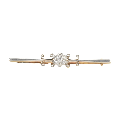 15 - An early 20th century diamond yellow and white metal bar brooch, unmarked, the central cluster set w... 