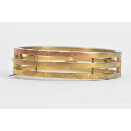16 - A late Victorian seed pearl and diamond yellow gold hinged bangle, unmarked, of openwork triple-band... 