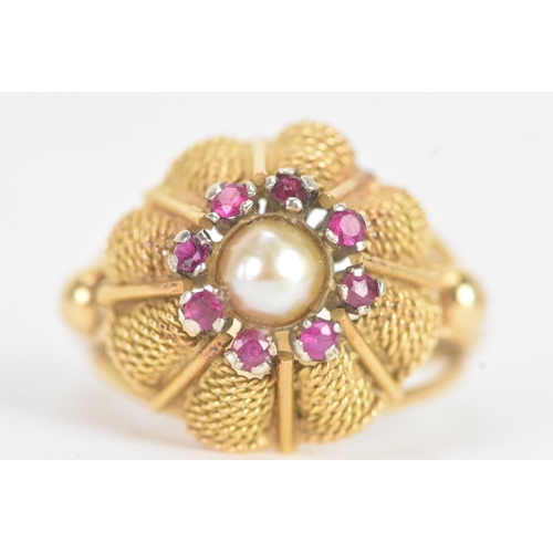 17 - A pearl and ruby yellow gold dress ring, unmarked, the flowerhead cluster centred by a pearl within ... 