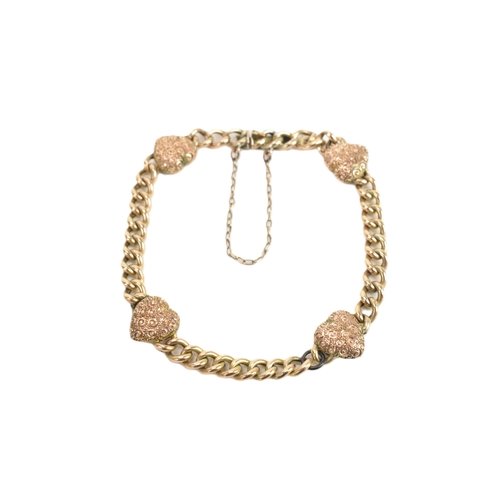 19 - A yellow gold curb link chain bracelet, unmarked, the curb links interspersed with four heart shaped... 