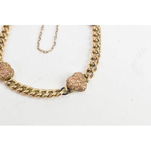 19 - A yellow gold curb link chain bracelet, unmarked, the curb links interspersed with four heart shaped... 