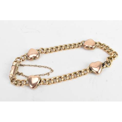 19 - A yellow gold curb link chain bracelet, unmarked, the curb links interspersed with four heart shaped... 