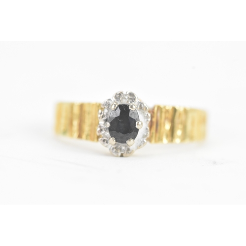 20 - A sapphire and diamond 18ct gold ring, the central claw setting sapphire surrounded by small diamond... 