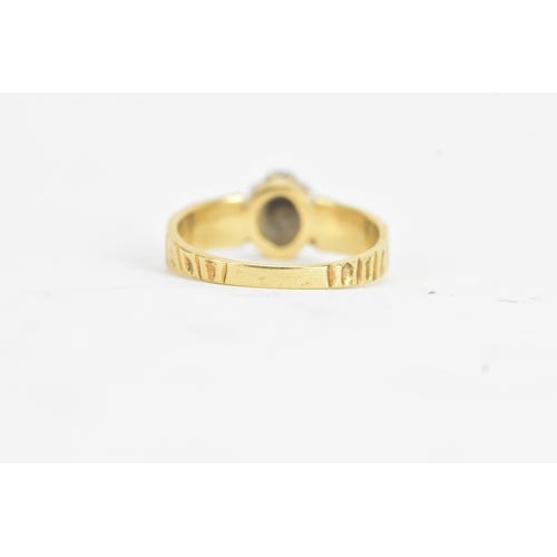 20 - A sapphire and diamond 18ct gold ring, the central claw setting sapphire surrounded by small diamond... 