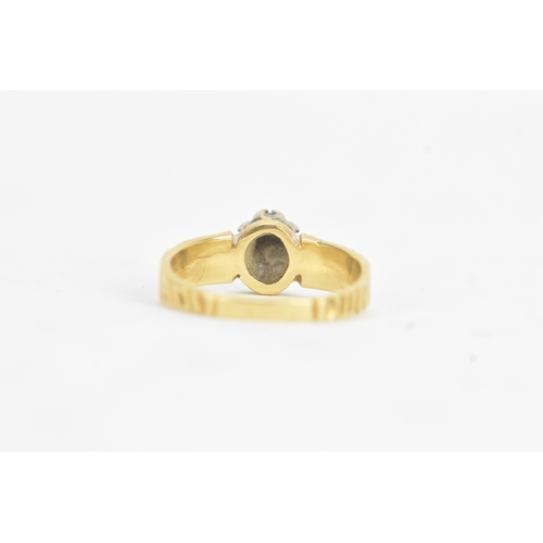 20 - A sapphire and diamond 18ct gold ring, the central claw setting sapphire surrounded by small diamond... 