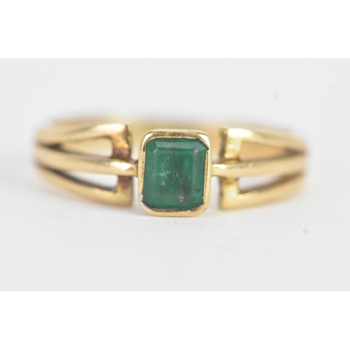 26 - An emerald 18ct yellow gold dress ring, the flush set emerald measuring approximately 4.2mm x 5mm, t... 
