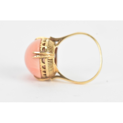 27 - A coral 18ct yellow gold dress ring, the large oval coral in a four claw setting measuring approxima... 