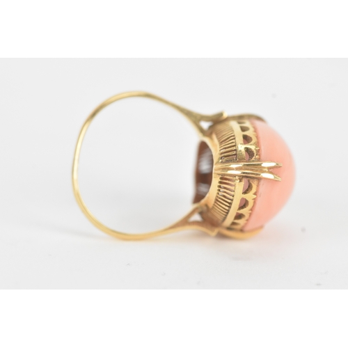 27 - A coral 18ct yellow gold dress ring, the large oval coral in a four claw setting measuring approxima... 