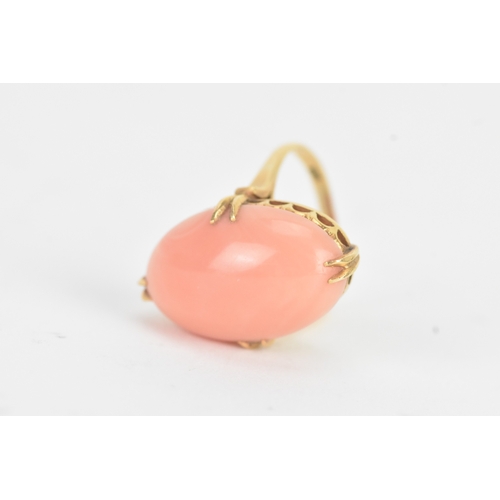 27 - A coral 18ct yellow gold dress ring, the large oval coral in a four claw setting measuring approxima... 