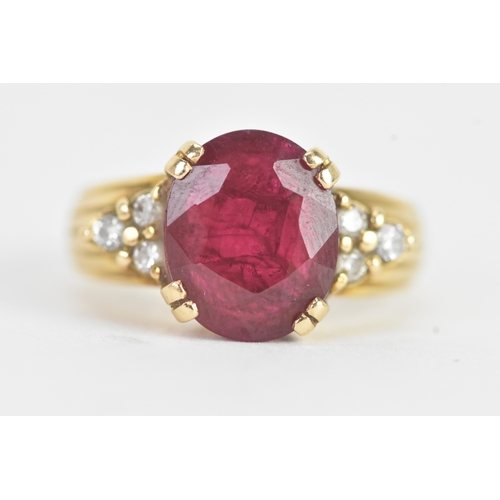 28 - A ruby and diamond 18ct gold ring, the oval ruby in a four claw setting measuring approximately 11.2... 