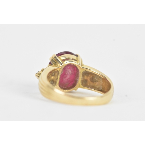 28 - A ruby and diamond 18ct gold ring, the oval ruby in a four claw setting measuring approximately 11.2... 