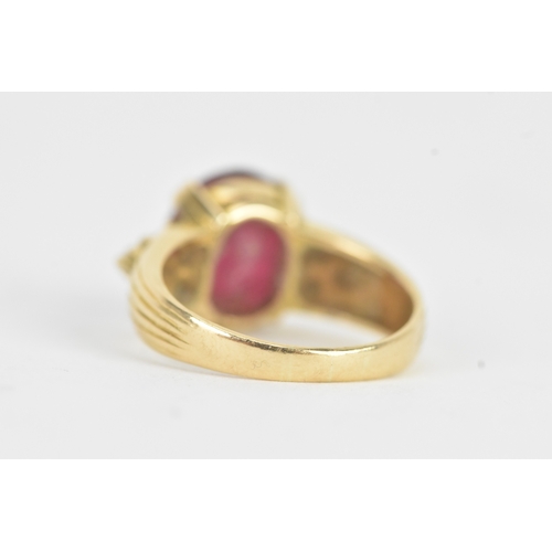 28 - A ruby and diamond 18ct gold ring, the oval ruby in a four claw setting measuring approximately 11.2... 