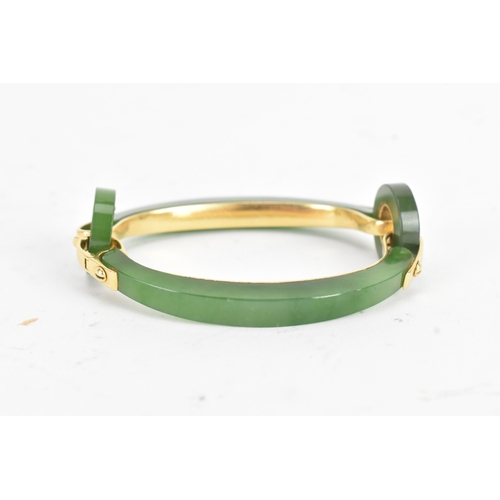 30 - A jade 18ct gold articulated bangle, composed of two curved and two circular polished jade sections ... 