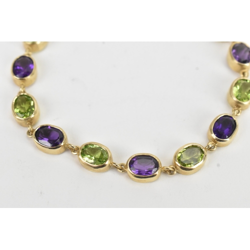 32 - A 9ct yellow gold bracelet featuring alternating oval-cut amethyst and peridots in a rub over settin... 