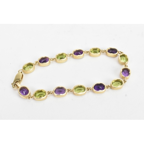 32 - A 9ct yellow gold bracelet featuring alternating oval-cut amethyst and peridots in a rub over settin... 