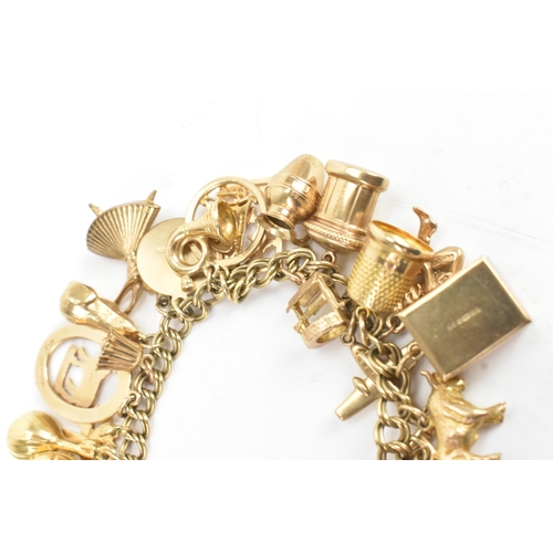 37 - A 9ct yellow gold double link charm link bracelet, having a heart shaped padlock clasp, having a lar... 