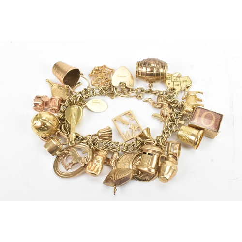 37 - A 9ct yellow gold double link charm link bracelet, having a heart shaped padlock clasp, having a lar... 