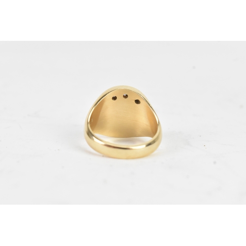 41 - A modern three stone diamond 10k yellow gold signet ring, engraved monogram letter 'M' and three ver... 