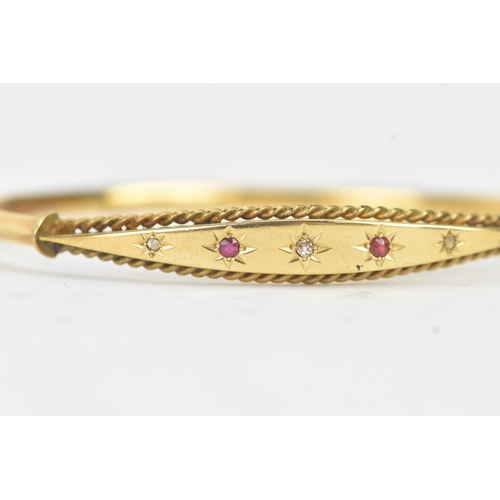 45 - A Victorian starburst set diamond and ruby 9ct yellow gold bangle,  featuring alternating round face... 