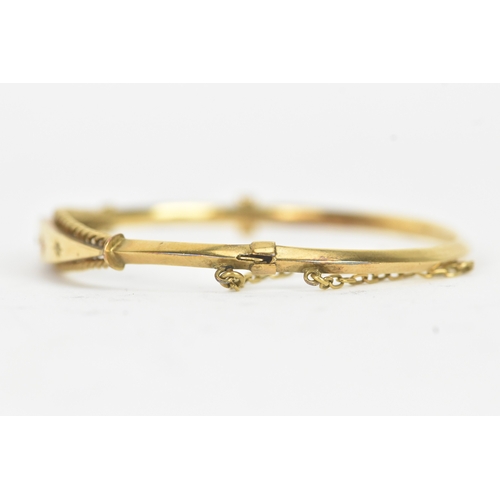 45 - A Victorian starburst set diamond and ruby 9ct yellow gold bangle,  featuring alternating round face... 
