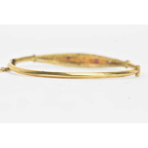 45 - A Victorian starburst set diamond and ruby 9ct yellow gold bangle,  featuring alternating round face... 