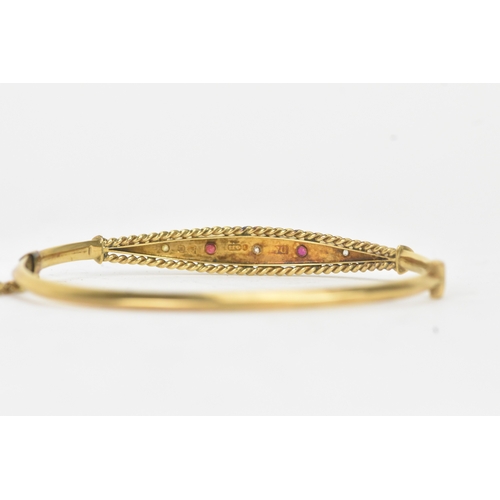 45 - A Victorian starburst set diamond and ruby 9ct yellow gold bangle,  featuring alternating round face... 