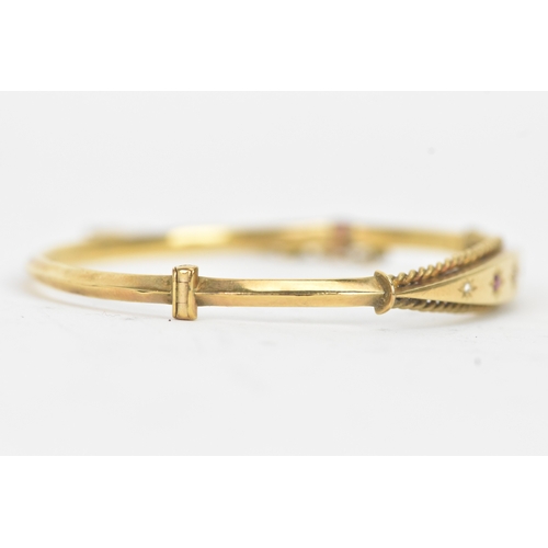 45 - A Victorian starburst set diamond and ruby 9ct yellow gold bangle,  featuring alternating round face... 